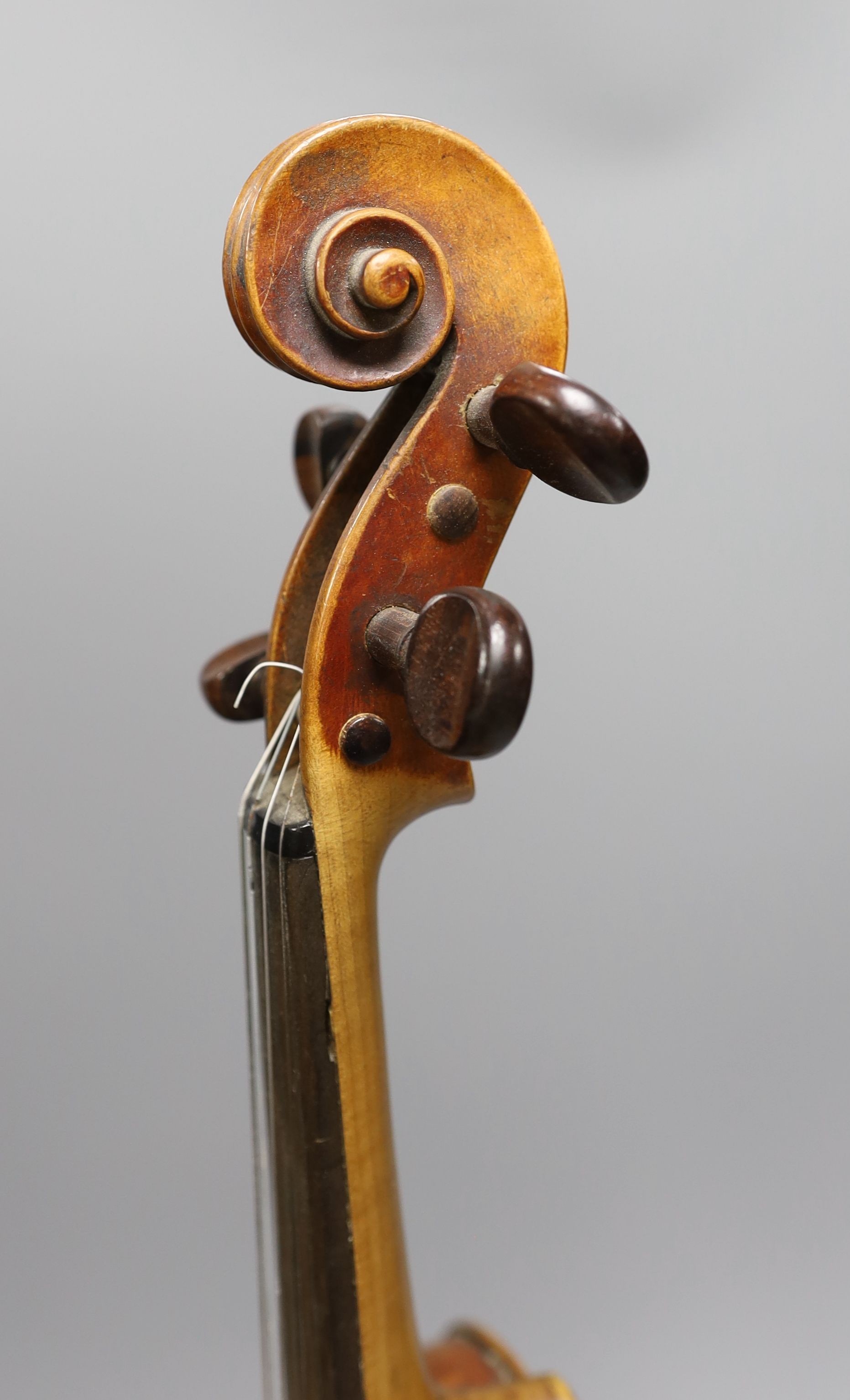 A 19th century violin with 14 inch 2 piece back, unlabelled, cased with silver mounted bow.